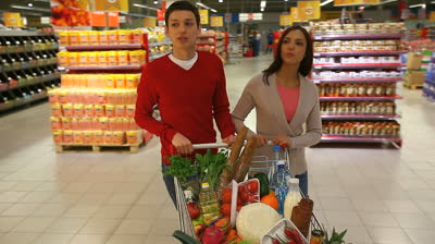 stock-footage-young-people-doing-shopping-together-in-a-modern-big-supermarket